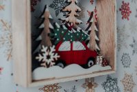 aap-best-cnc-router-projects-for-woodworking-gifts-1793155394 A close-up of a wooden Christmas ornament featuring a car and gift boxes, set against a festive background.