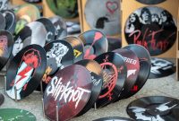aap-best-cricut-projects-to-sell-for-profit-1790870220 Collection of artistic vinyl records featuring iconic band designs on display at market.