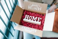 Box opened to reveal HOME decoration amidst red packing material, labeled Special Delivery.
