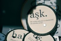 aap-best-embroidery-hoop-art-ideas-for-gifts-1791209453 Detailed view of round decorations with Turkish embroidery text on fabric.