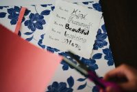 A beautifully crafted card celebrates motherhood with floral patterns and a heartfelt message.
