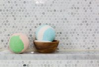 aap-diy-bath-bombs-with-natural-ingredients-1791900025 Colorful pastel bath bombs displayed on a marble surface for spa ambiance.