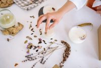 Creating handmade candles with dried flowers and leaves for unique decorations.